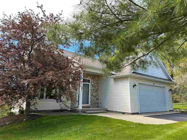6680 Hillside Dr, Harbor Springs, MI 49740 - view of property hidden behind natural elements with driveway, a front yard, and an attached garage