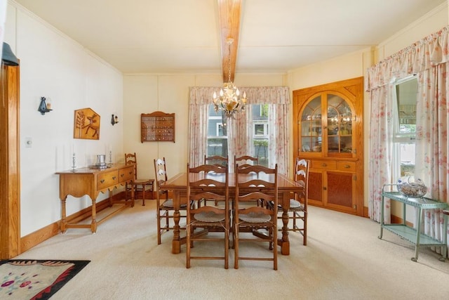 1788 N Shore Dr, Walloon Lake, MI 49796 - dining room featuring a chandelier, light colored carpet, and crown molding
