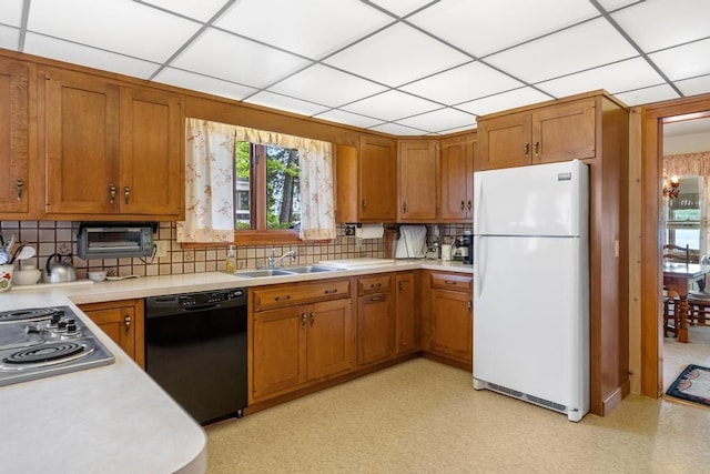 1788 N Shore Dr, Walloon Lake, MI 49796 - kitchen with freestanding refrigerator, dishwasher, a sink, brown cabinetry, and light countertops