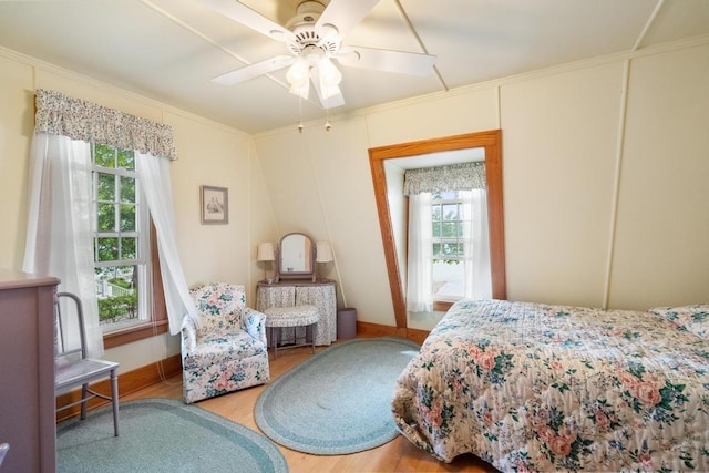 1788 N Shore Dr, Walloon Lake, MI 49796 - bedroom with crown molding, wood finished floors, baseboards, and ceiling fan