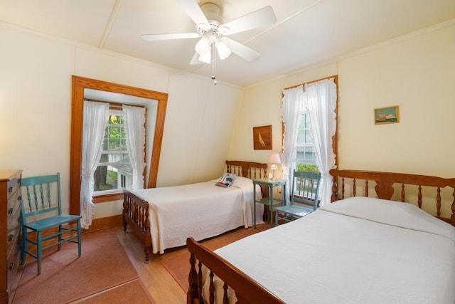 1788 N Shore Dr, Walloon Lake, MI 49796 - bedroom with crown molding, light wood-type flooring, ceiling fan, and baseboards