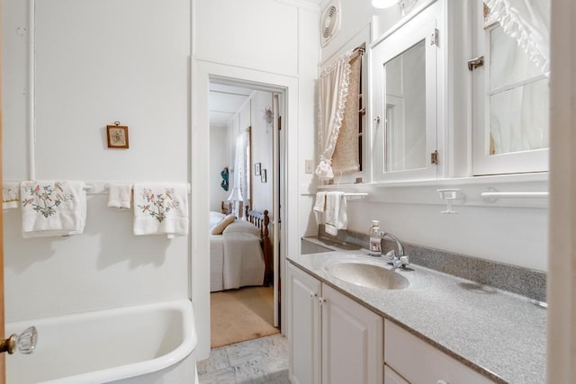 1788 N Shore Dr, Walloon Lake, MI 49796 - bathroom featuring vanity, a tub to relax in, and ensuite bath