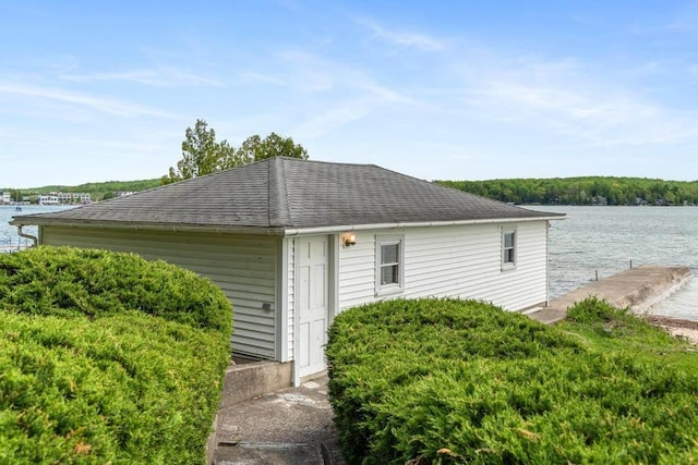 1788 N Shore Dr, Walloon Lake, MI 49796 - view of side of property with a dock, a water view, and roof with shingles