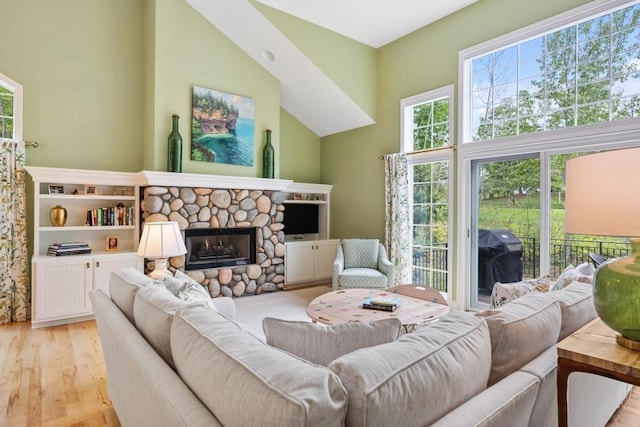 6707 Cottage Ct Unit 40, Bay Harbor, MI 49770 - living area with light wood-style flooring and a stone fireplace