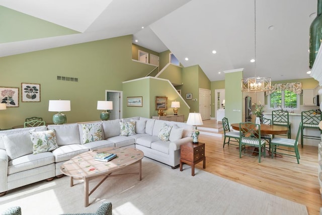 6707 Cottage Ct Unit 40, Bay Harbor, MI 49770 - living area with high vaulted ceiling, a chandelier, and light wood-style flooring