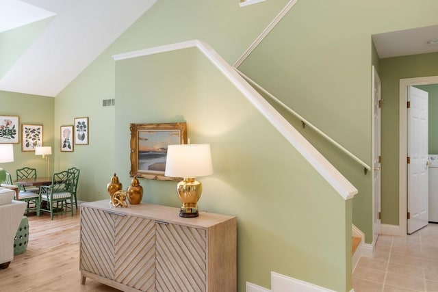 6707 Cottage Ct Unit 40, Bay Harbor, MI 49770 - corridor featuring stairs, baseboards, and high vaulted ceiling