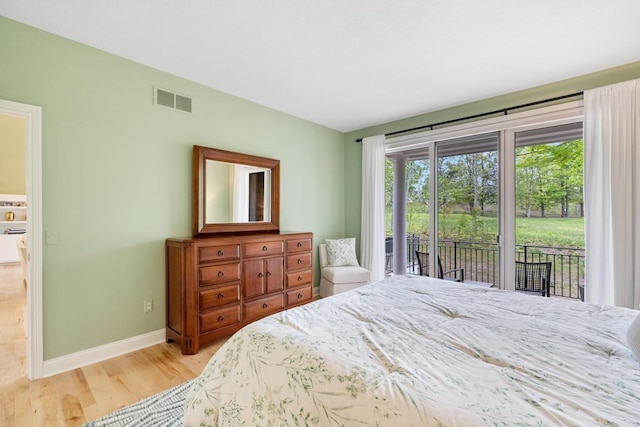 6707 Cottage Ct Unit 40, Bay Harbor, MI 49770 - bedroom with access to outside, light wood-style floors, and baseboards