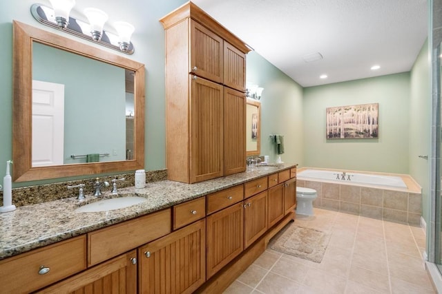 6707 Cottage Ct Unit 40, Bay Harbor, MI 49770 - bathroom featuring a bath, double vanity, toilet, and tile patterned floors
