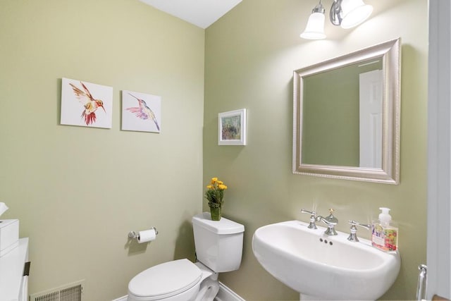 6707 Cottage Ct Unit 40, Bay Harbor, MI 49770 - half bathroom with toilet, a sink, and baseboards