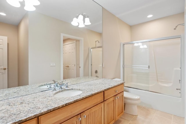 6707 Cottage Ct Unit 40, Bay Harbor, MI 49770 - bathroom featuring toilet, vanity, combined bath / shower with glass door, and tile patterned floors
