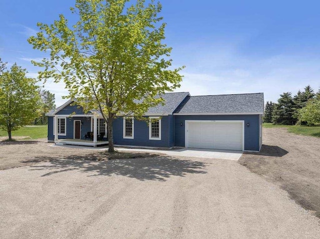 7748 Sophies Way, Harbor Springs, MI 49740 - view of front facade with a garage, driveway, a porch, and roof with shingles