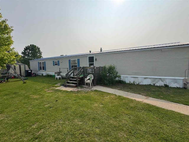 59 Tamarack Dr, East Jordan, MI 49727 - back of house with a yard and a deck