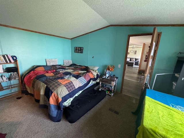 59 Tamarack Dr, East Jordan, MI 49727 - carpeted bedroom featuring vaulted ceiling, ornamental molding, and a textured ceiling