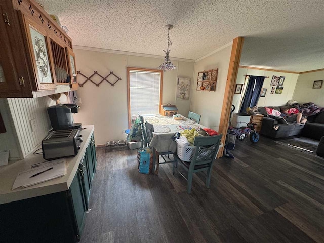 59 Tamarack Dr, East Jordan, MI 49727 - dining space featuring ornamental molding, dark wood-style flooring, and a textured ceiling