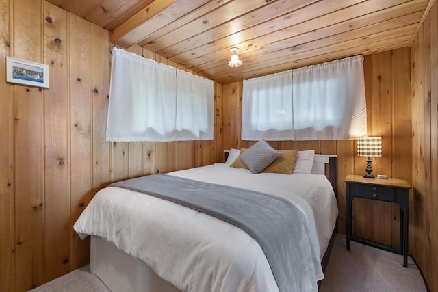 21677 Bluffs Hwy, Onaway, MI 49765 - bedroom with wood ceiling, wood walls, and carpet flooring
