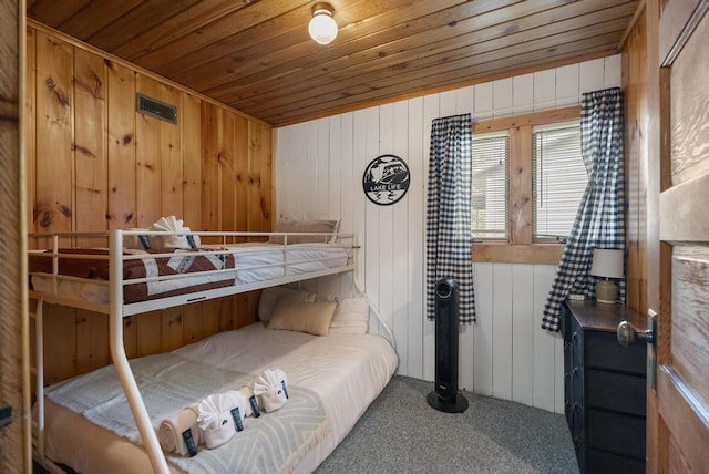 21677 Bluffs Hwy, Onaway, MI 49765 - carpeted bedroom with wooden ceiling and wooden walls