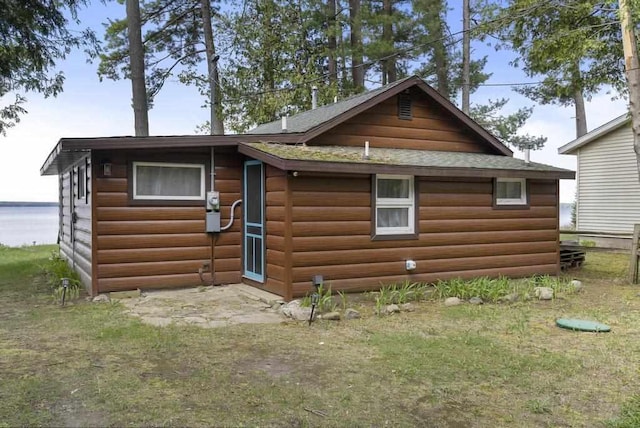 21677 Bluffs Hwy, Onaway, MI 49765 - back of house with faux log siding and roof with shingles