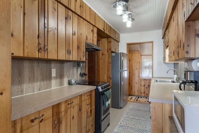 21677 Bluffs Hwy, Onaway, MI 49765 - kitchen featuring freestanding refrigerator, electric range oven, light countertops, under cabinet range hood, and white microwave
