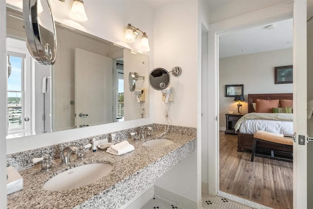 824 Vista Dr Unit 64, Bay Harbor, MI 49770 - ensuite bathroom featuring double vanity, plenty of natural light, and baseboards