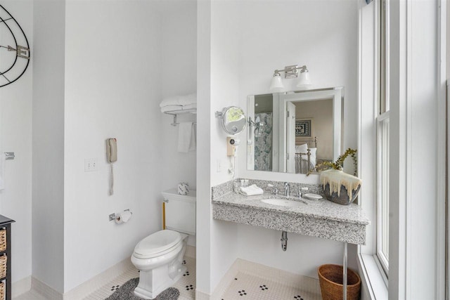 824 Vista Dr Unit 64, Bay Harbor, MI 49770 - bathroom with a sink, toilet, tile patterned floors, and baseboards