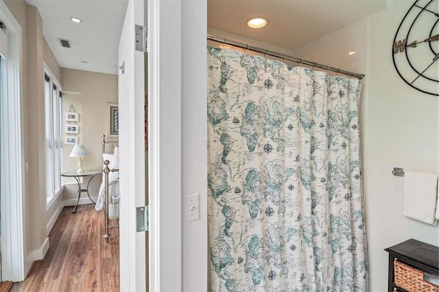 824 Vista Dr Unit 64, Bay Harbor, MI 49770 - full bathroom featuring wood finished floors, recessed lighting, baseboards, and a shower with curtain