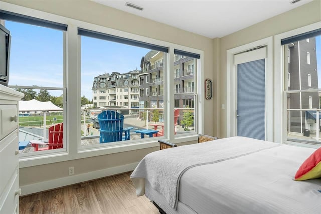 824 Vista Dr Unit 64, Bay Harbor, MI 49770 - bedroom featuring wood finished floors and multiple windows