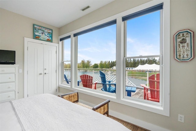 824 Vista Dr Unit 64, Bay Harbor, MI 49770 - bedroom featuring a water view, multiple windows, and a closet