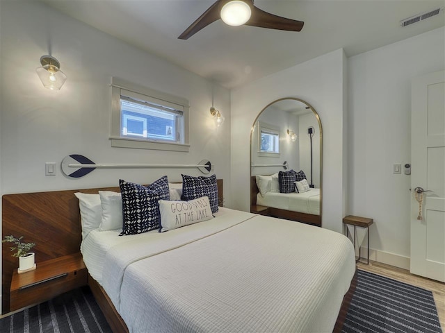 103 Riverwalk Ln Unit 103, Charlevoix, MI 49720 - bedroom featuring wood finished floors, ceiling fan, and baseboards