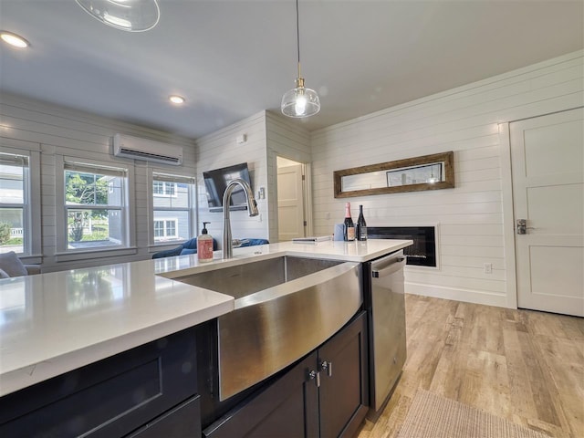 103 Riverwalk Ln Unit 103, Charlevoix, MI 49720 - kitchen featuring a wall mounted AC, dishwasher, a sink, light countertops, and light wood-style flooring