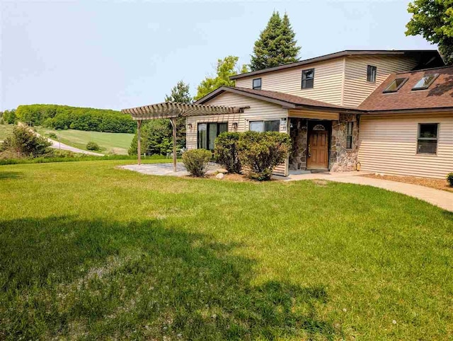 8748 Nelson Rd, East Jordan, MI 49727 - view of front of house with a pergola, a front lawn, stone siding, and a patio area
