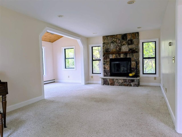 8748 Nelson Rd, East Jordan, MI 49727 - unfurnished living room featuring a baseboard radiator, carpet, a fireplace, and baseboards