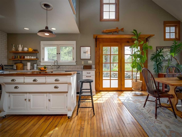 7671 Hoyt Rd, Harbor Springs, MI 49740 - kitchen featuring french doors, white cabinetry, light wood-type flooring, and recessed lighting