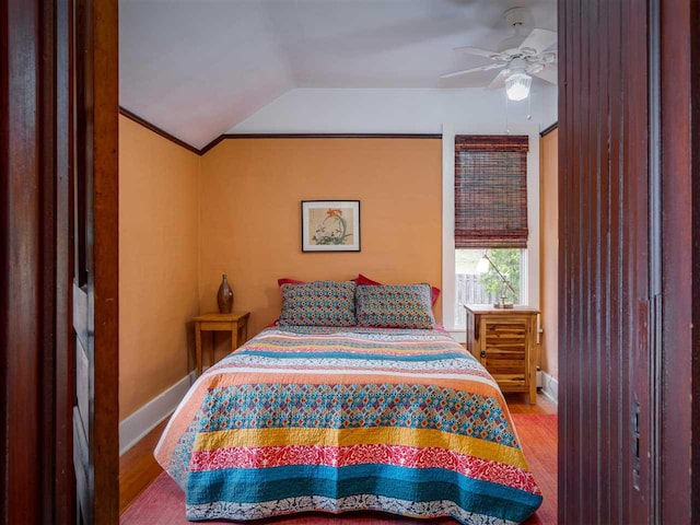 7671 Hoyt Rd, Harbor Springs, MI 49740 - bedroom with wood finished floors, vaulted ceiling, baseboards, and a ceiling fan