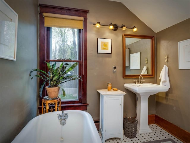 7671 Hoyt Rd, Harbor Springs, MI 49740 - bathroom with a freestanding tub, vaulted ceiling, and baseboards