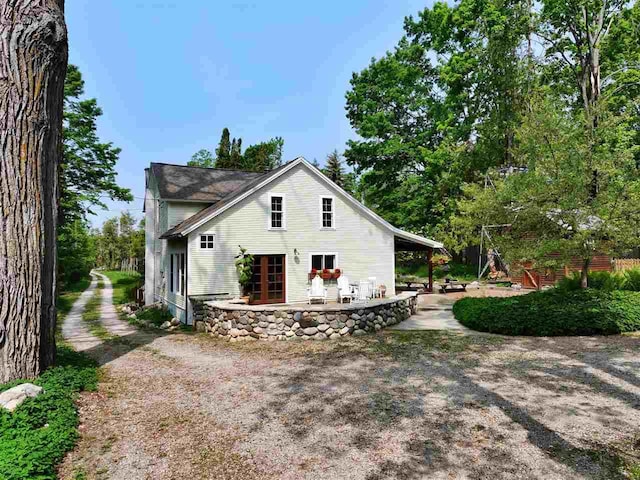 7671 Hoyt Rd, Harbor Springs, MI 49740 - rear view of house with a patio area