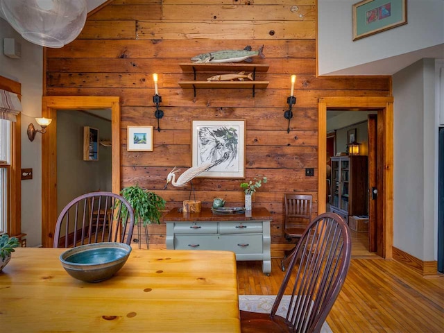 7671 Hoyt Rd, Harbor Springs, MI 49740 - dining room featuring wood walls and light wood-type flooring
