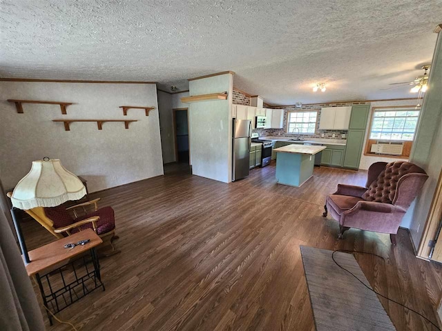 394 Townline Rd, Pellston, MI 49769 - living area with dark wood finished floors, cooling unit, a ceiling fan, and a textured ceiling