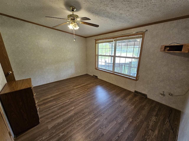 394 Townline Rd, Pellston, MI 49769 - empty room with crown molding, dark wood-style floors, ceiling fan, a textured ceiling, and a textured wall