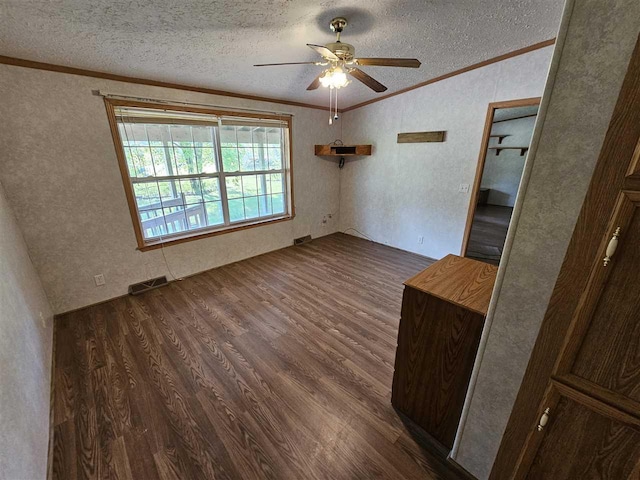 394 Townline Rd, Pellston, MI 49769 - spare room with dark wood-type flooring, vaulted ceiling, ornamental molding, a textured ceiling, and a ceiling fan