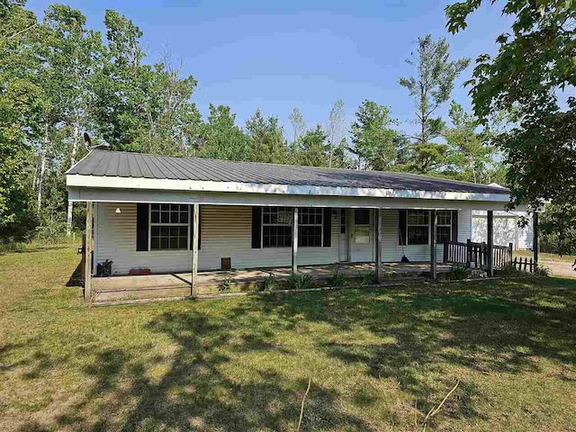 394 Townline Rd, Pellston, MI 49769 - ranch-style home featuring a front yard, covered porch, and metal roof