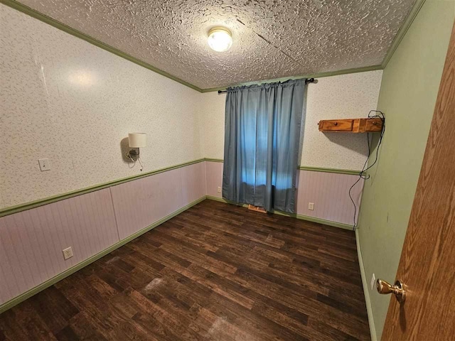 394 Townline Rd, Pellston, MI 49769 - unfurnished room with wood finished floors, crown molding, a wainscoted wall, and a textured ceiling