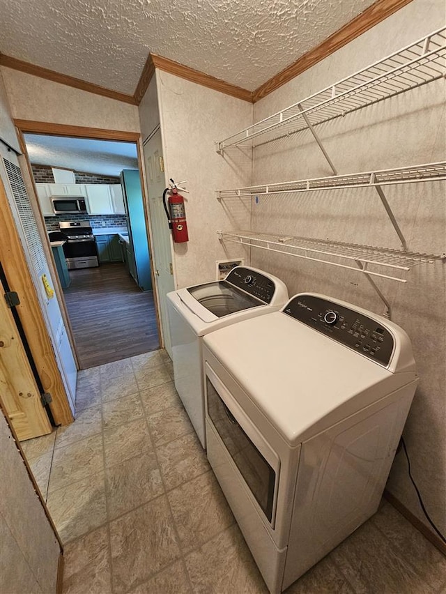 394 Townline Rd, Pellston, MI 49769 - washroom featuring washer and dryer, crown molding, a textured ceiling, and a textured wall