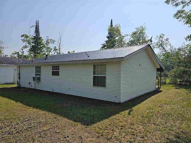 394 Townline Rd, Pellston, MI 49769 - view of home's exterior featuring a yard, cooling unit, and metal roof