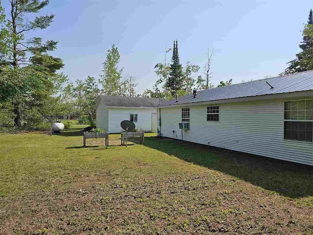 394 Townline Rd, Pellston, MI 49769 - rear view of house featuring a lawn, metal roof, and cooling unit