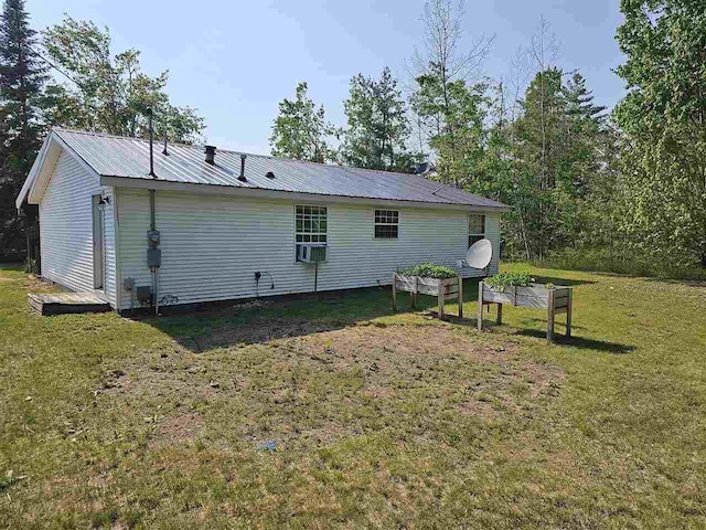 394 Townline Rd, Pellston, MI 49769 - rear view of house featuring metal roof, a yard, and cooling unit