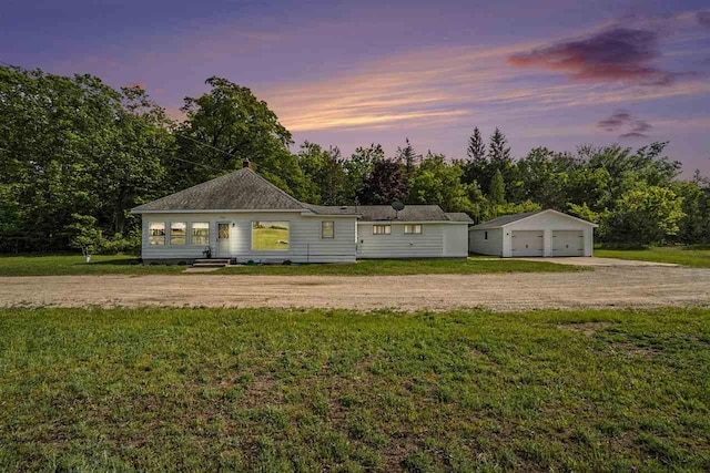 5791 Lebaron St, Levering, MI 49755 - view of front of house with an outdoor structure, a garage, a front lawn, and dirt driveway
