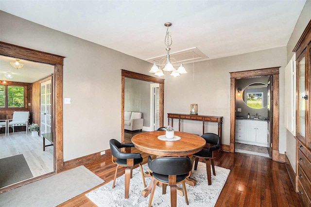 5791 Lebaron St, Levering, MI 49755 - dining room featuring hardwood / wood-style floors, attic access, and baseboards