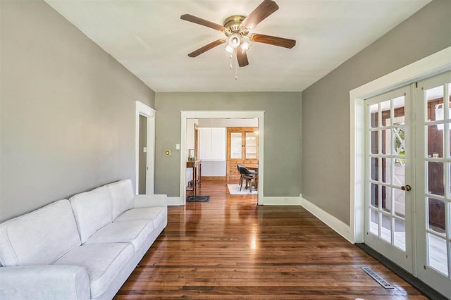 5791 Lebaron St, Levering, MI 49755 - living area featuring dark wood-style floors, french doors, a ceiling fan, and baseboards