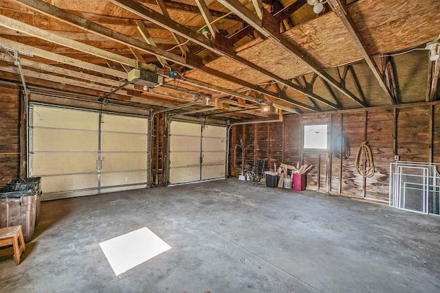 5791 Lebaron St, Levering, MI 49755 - garage featuring a garage door opener