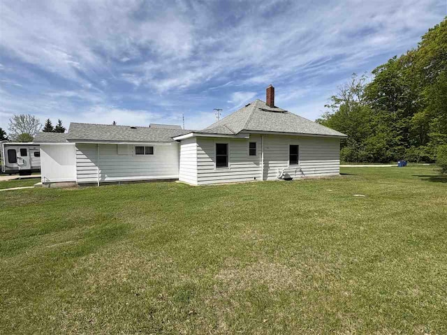 5791 Lebaron St, Levering, MI 49755 - back of property featuring a lawn and a shingled roof
